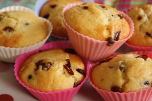 White Chocolate Cherry Muffins: A pile of muffins in pink silicon cases