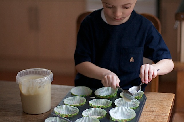 Spooning ready made cake mix into cases at development.maisoncupcake.com