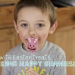Easter Bunny Pops - a small boy holds a small pink chocolate bunny on a stick in front of his face.