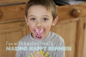 Easter Bunny Pops - a small boy holds a small pink chocolate bunny on a stick in front of his face.