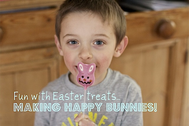 Easter Bunny Pops - a small boy holds a small pink chocolate bunny on a stick in front of his face. 