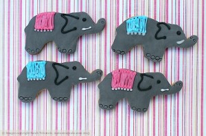 Elephant cookies decorated with grey sugarpaste and iced pink and blue decoration