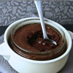 Mint Chocolate Puddings with After Eight - served in glass ramekins set inside larger white dish. A spoon is dipped into the gooey melting centre.