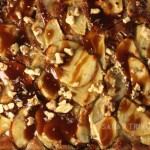 Close up of Toffee Apple Tart showing apple slices, toffee sauce, chopped nuts