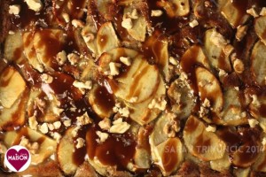 Close up of Toffee Apple Tart showing apple slices, toffee sauce, chopped nuts