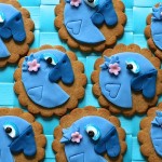 Cute Rio 2 blue parrot cookies decorated with blue sugarpaste and pink flowers