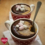 Pumpkin Mug Cakes with Chocolate Sauce - two mug cakes served in spotty red mugs and topped with mini marshmallows