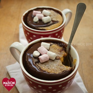 Pumpkin Mug Cakes with Chocolate Sauce - two mug cakes served in spotty red mugs and topped with mini marshmallows