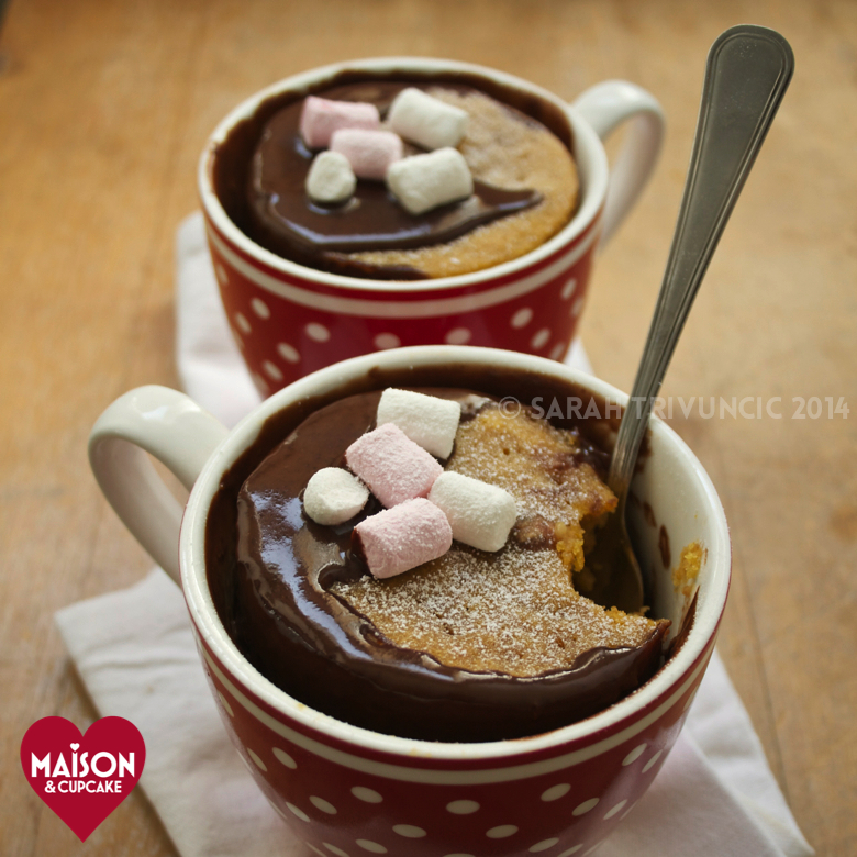 Pumpkin Mug Cakes with Chocolate Sauce - two mug cakes served in spotty red mugs and topped with mini marshmallows