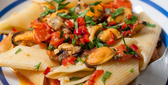 Pennoni chilli mussels - giant pasta recipe in a striped blue white bowl.