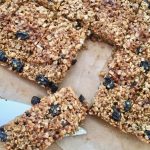 Twelve raisin flapjacks cut into rectangles