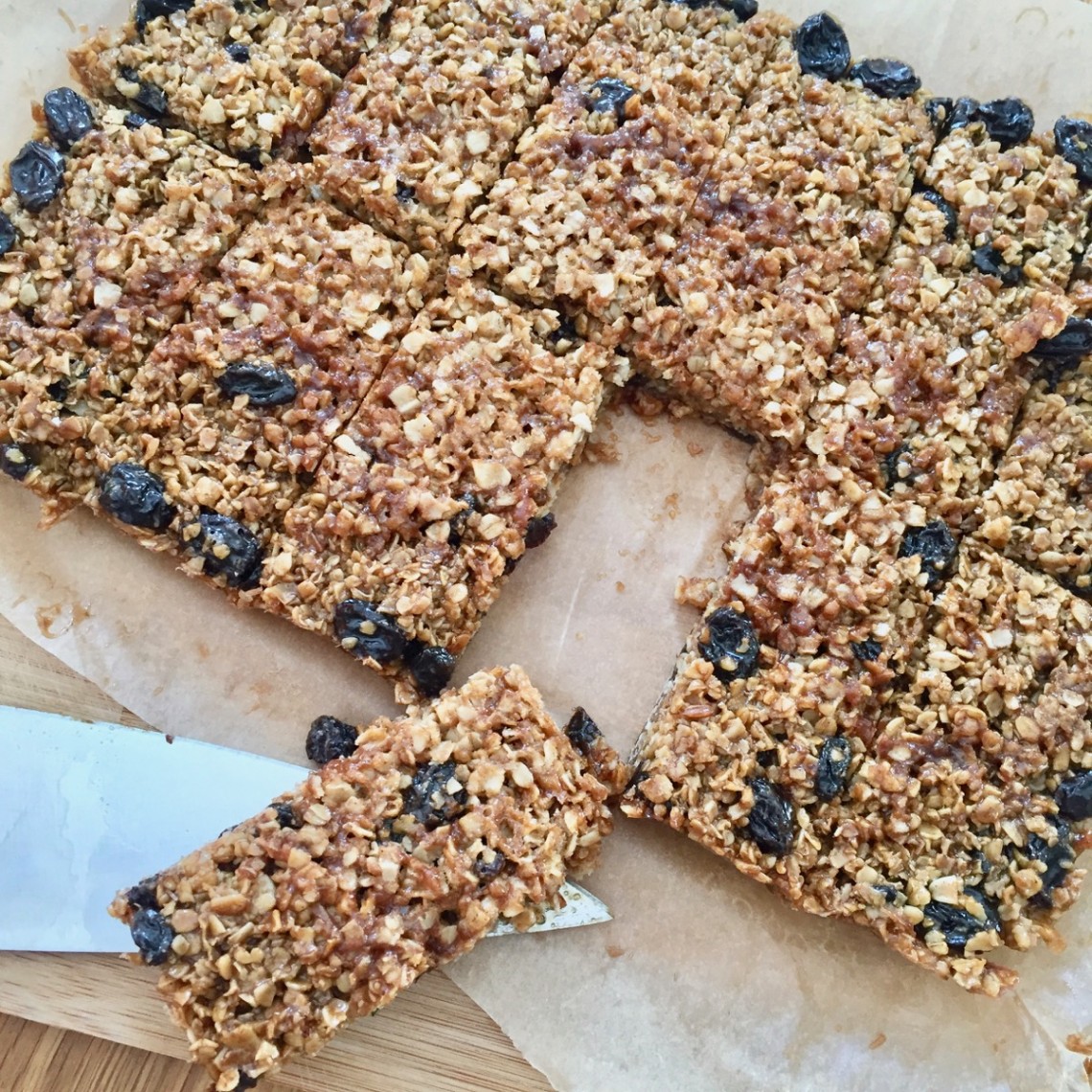 Twelve raisin flapjacks cut into rectangles